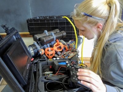 A member of the SOAR team troubleshoots one of the service grade ROVs.