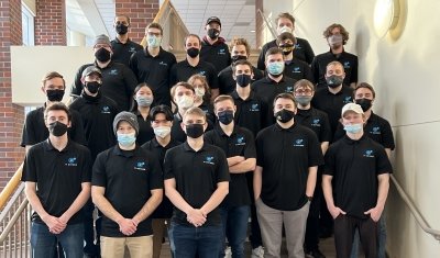 IT Oxygen team standing on stairs in a building