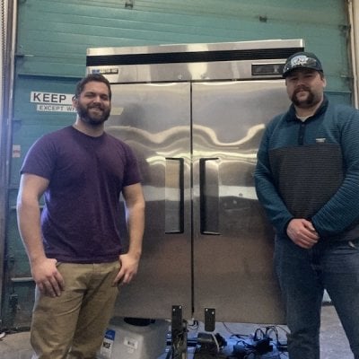 two people standing infront of large chamber