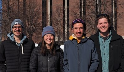 four people posing for a photo