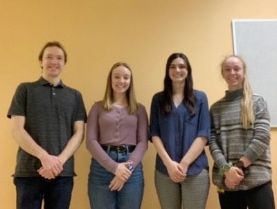 four people posing for a photo