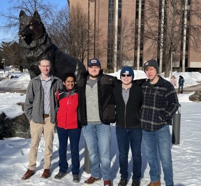 five people posing for a photo