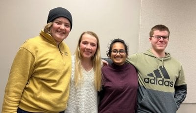 four people posing for a photo