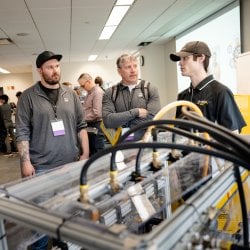 students discussing their design expo project with judges