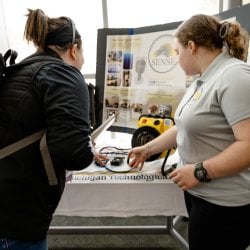 a student discussing their design expo project with a judge