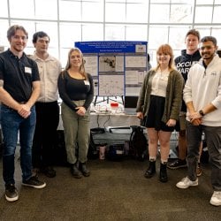 students discussing their design expo project with judges