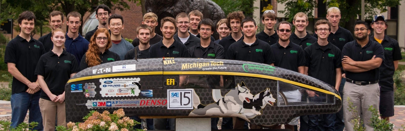 Supermileage Systems Enterprise team pose with their vehicle