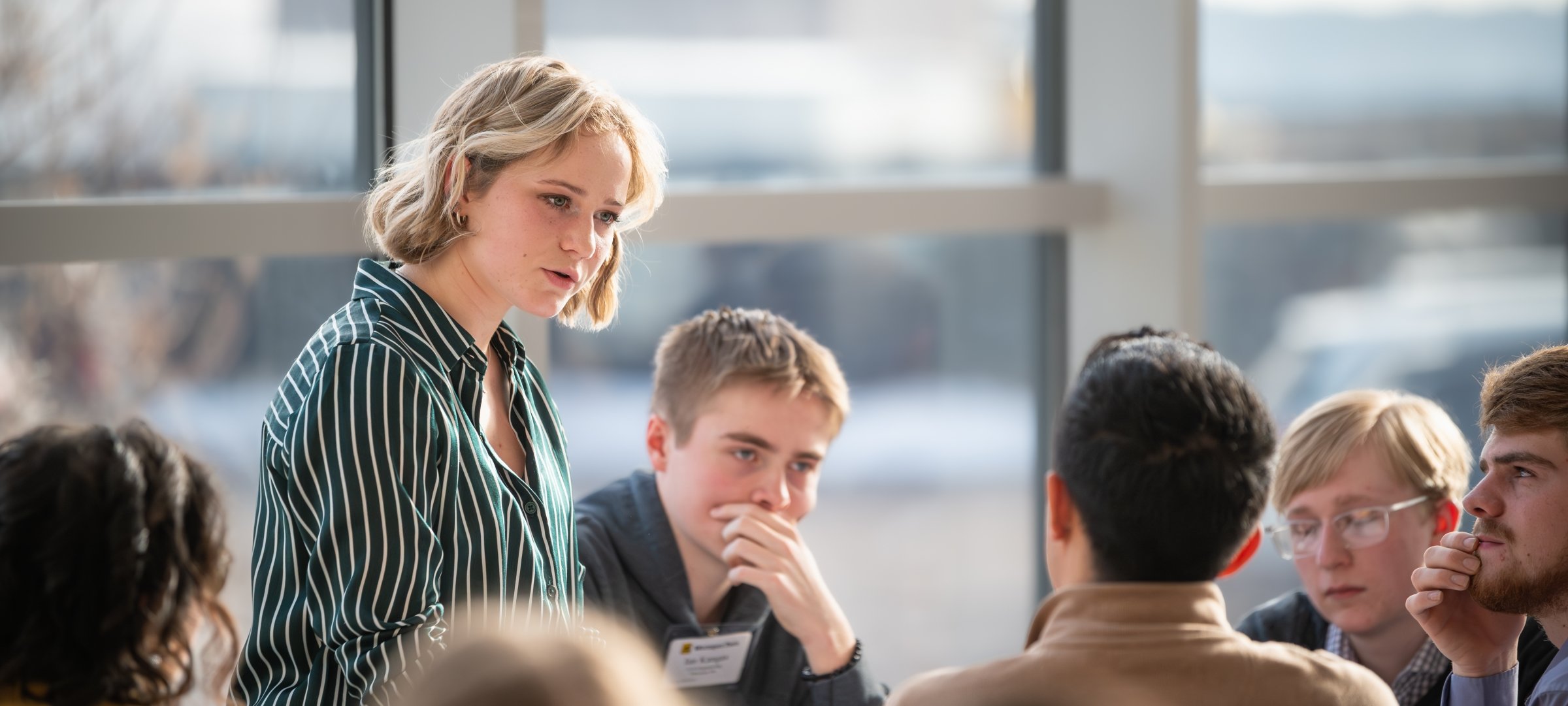 Student speaking to a group of peers.