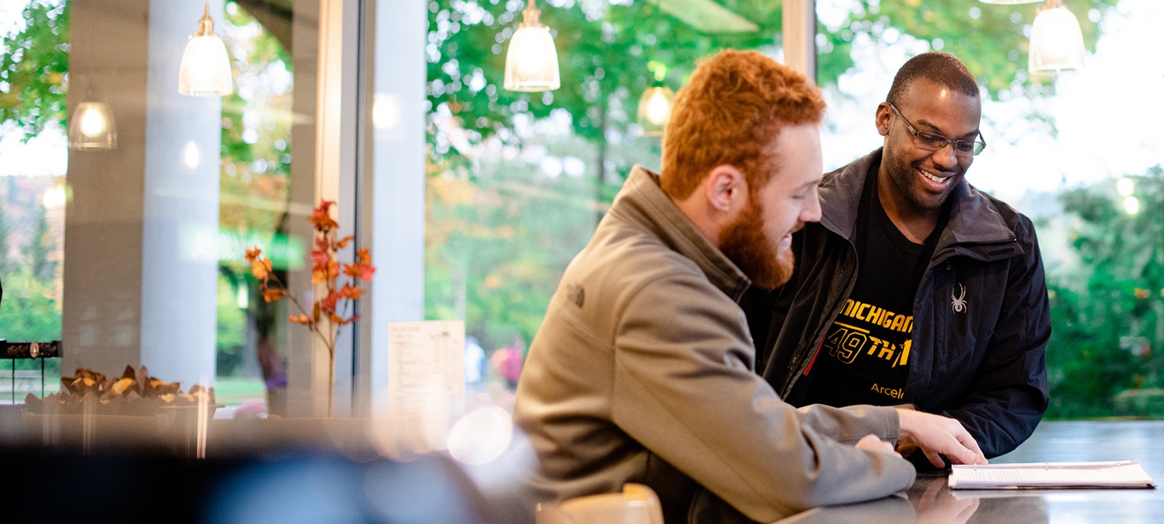 Two students studying at the library cafe