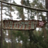 wooden sign that says "welcome" in swedish