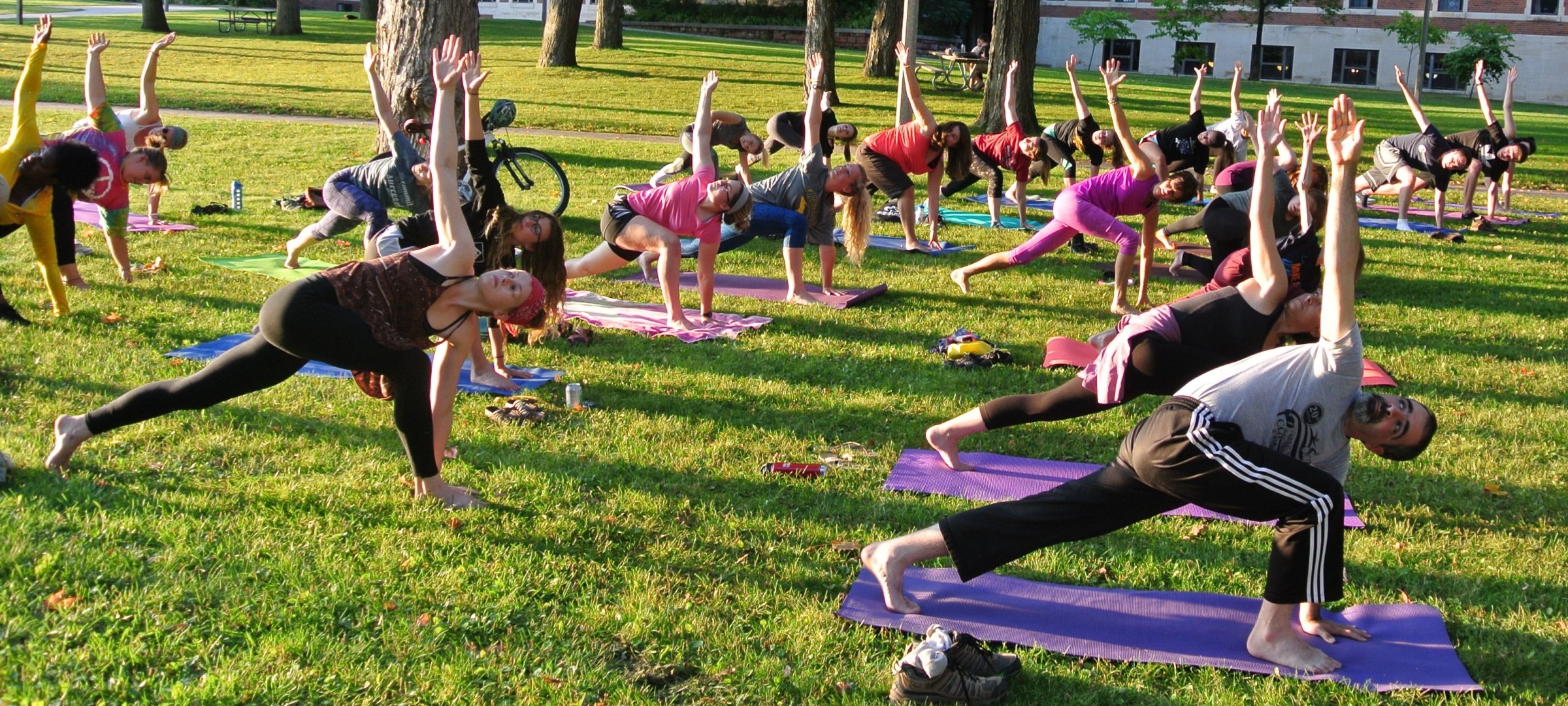 Students doing yoga on the Walker lawn.