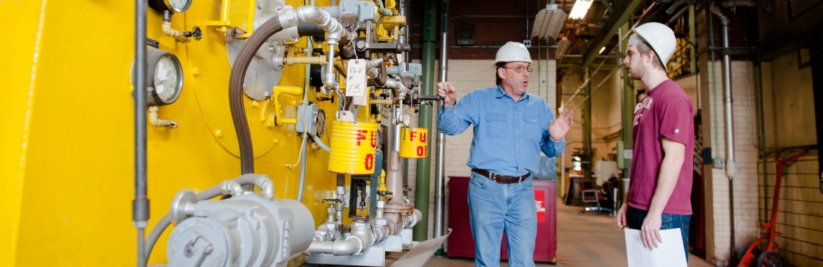 Energy Management staff reviewing a heating system.