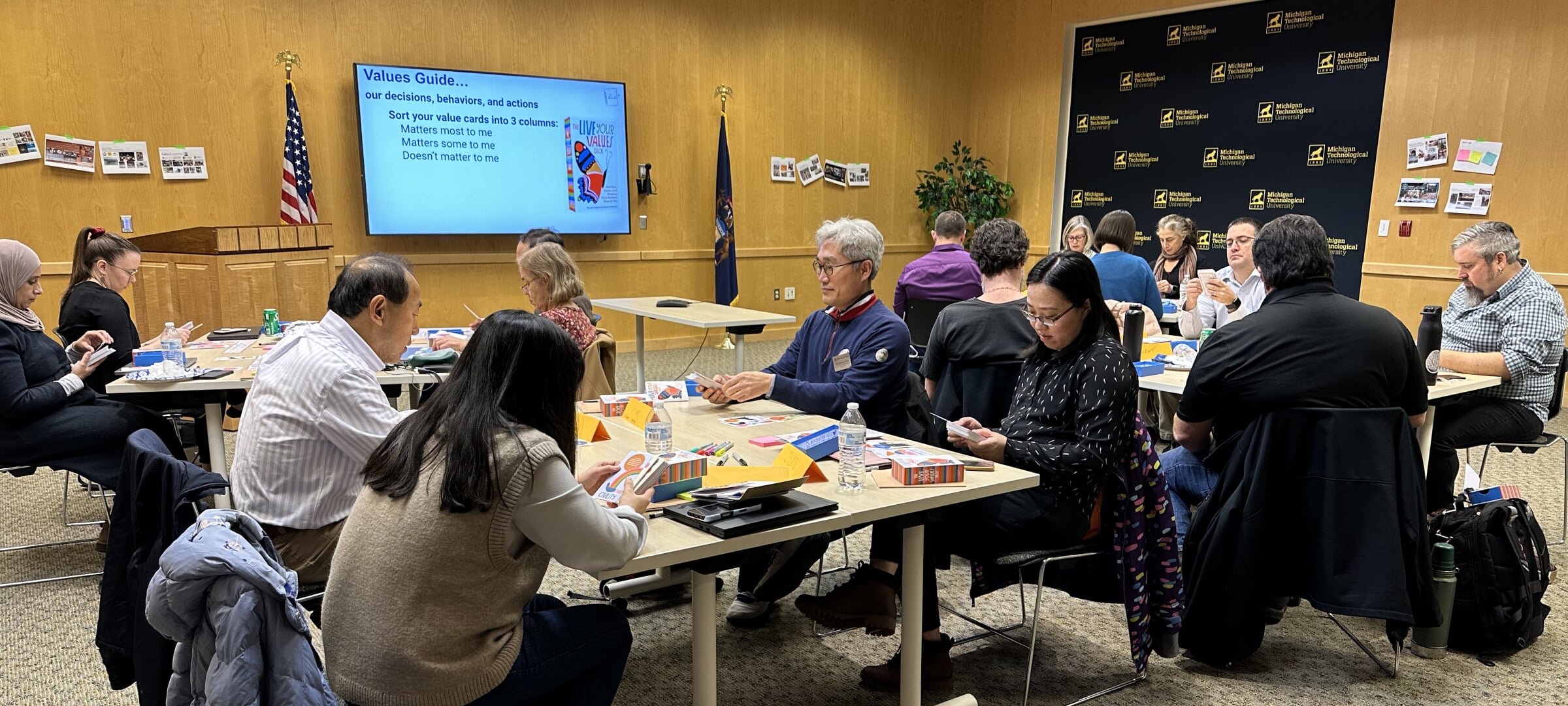 Faculty seated at table during a professional development event.