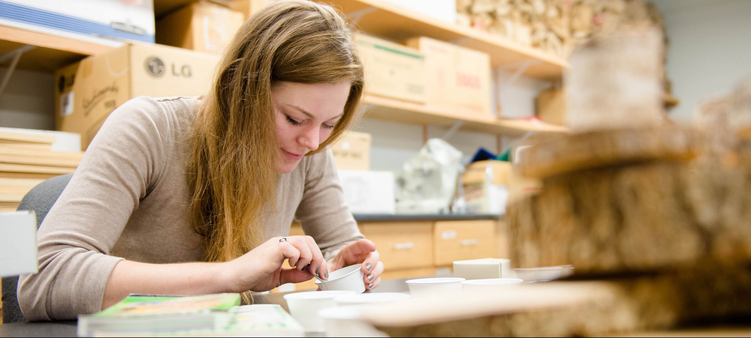 Student working on wood samples in the lab.