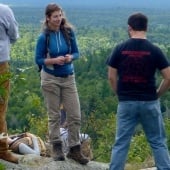 Students on a cliff overlooking a forest.