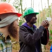 Students in hard hats taking measurements