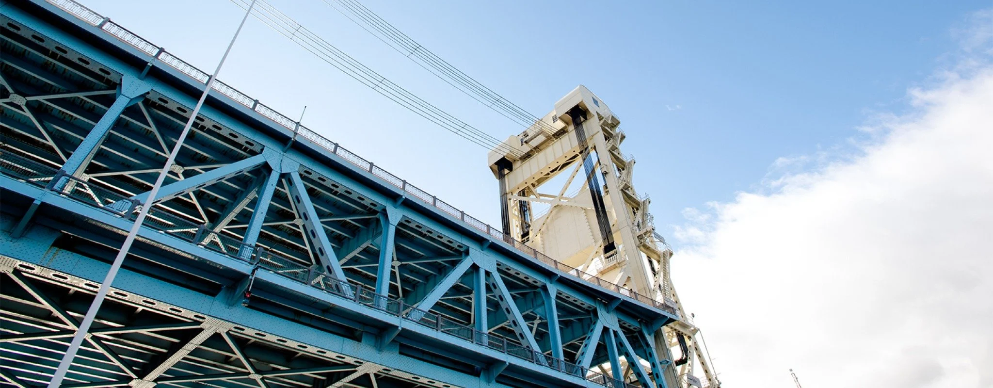 A view of the Portage Lake lift bridge on a blue sky summer day. 