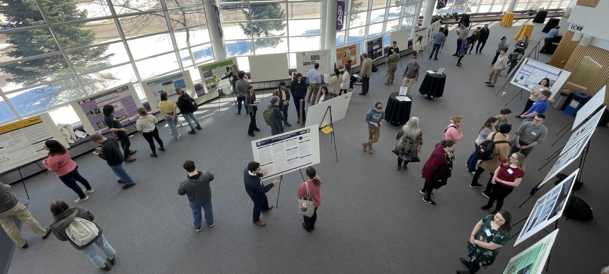 A view of a lobby in which students are presenting academic posters.