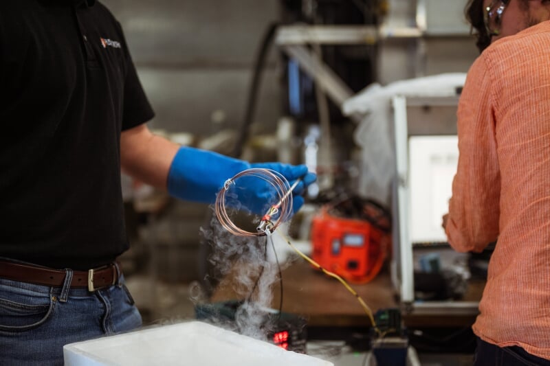 Watts on the Moon NASA Test, Researcher holding a spiraled wire with smoke