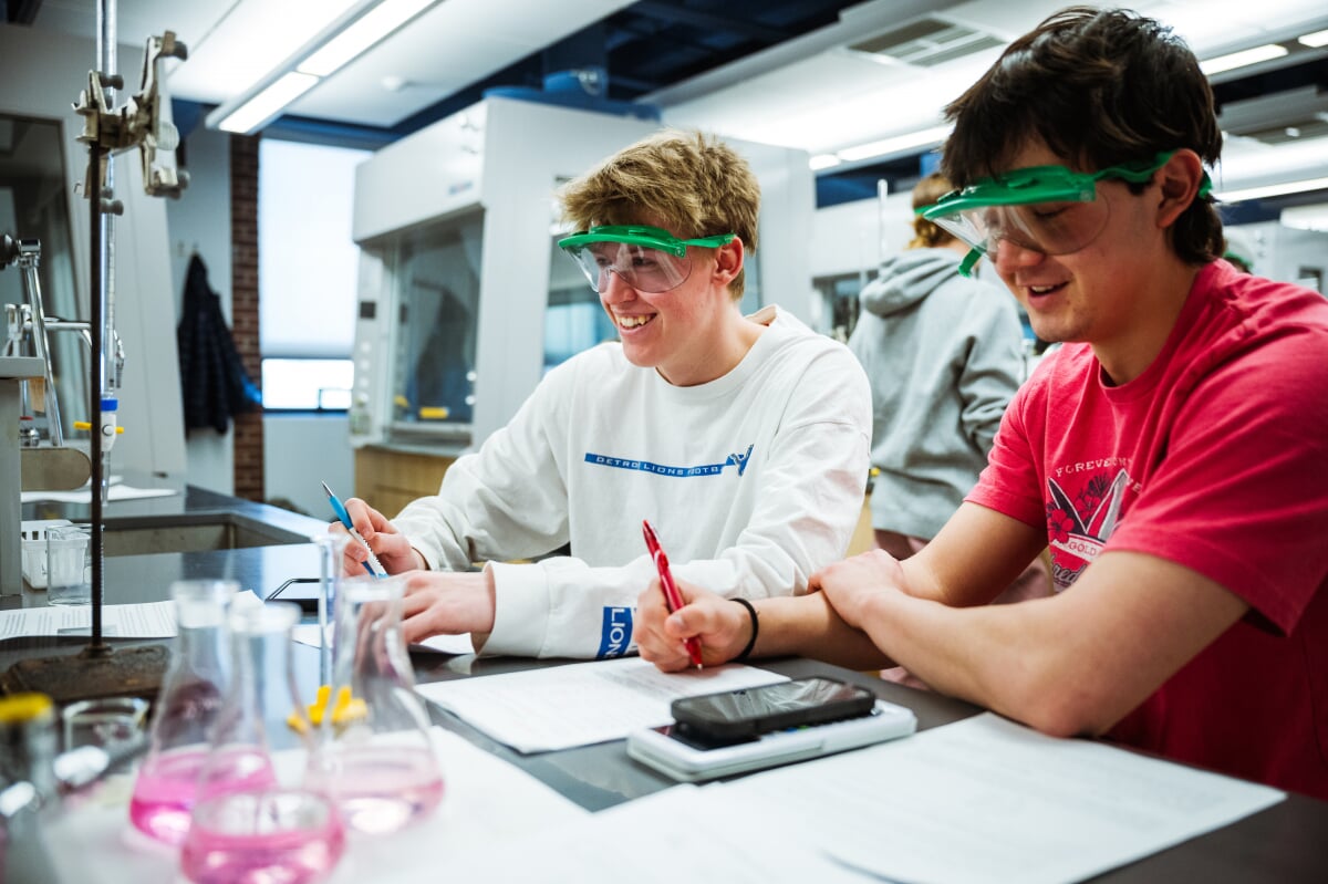 Two First Year students in a lab with safety glasses