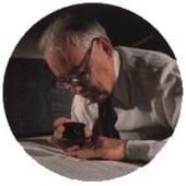 Charles Richter examines a seismogram on a table.