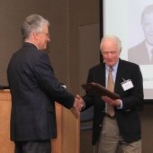 Aleksey Smirnov gives Dan Farrell his plaque