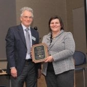 Aleksey and Julie standing with Julie's plaque