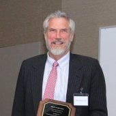 Brian Schwanitz holding his Academy plaque
