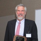 Brian Schwanitz holding his Academy plaque