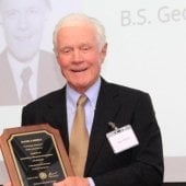 Dan Farrell holds plaque