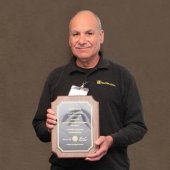 Dave Adler holds his plaque