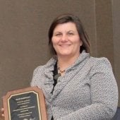 Julie Marinucci holds her plaque