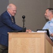 Richard and Jeremy shake hands at podium