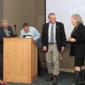 Aleksey Smirnov, Jeremy Shannon, John Gierke, and Janet Callahan at podium