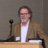 Todd Stone speaking at podium
