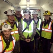 Society for Mining, Metallurgy, and Exploration students wearing vests and hardhats.