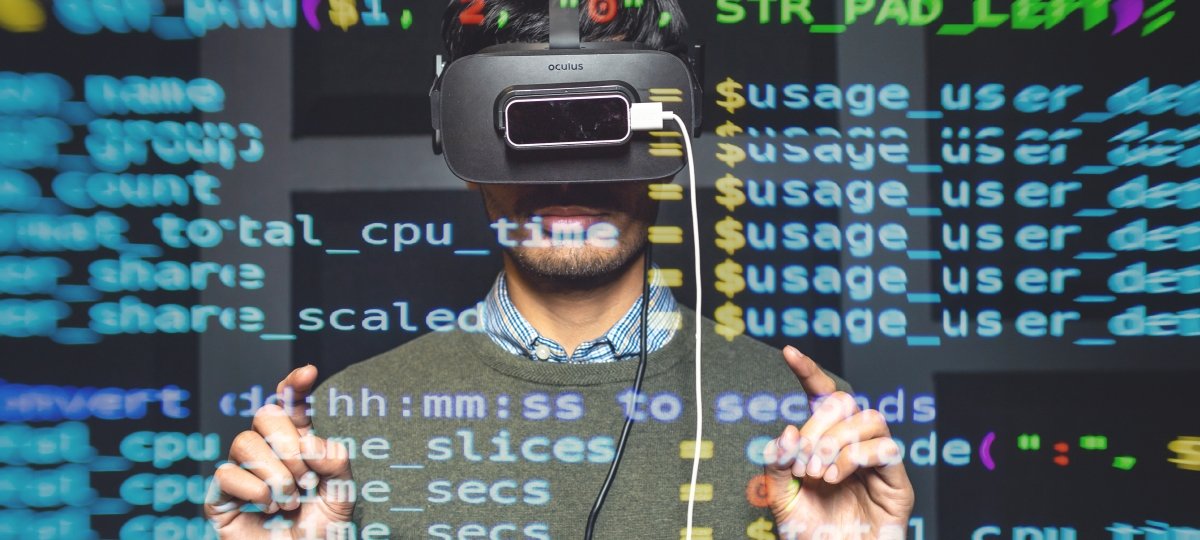 Person wearing a virtual reality headset overlaid with code.