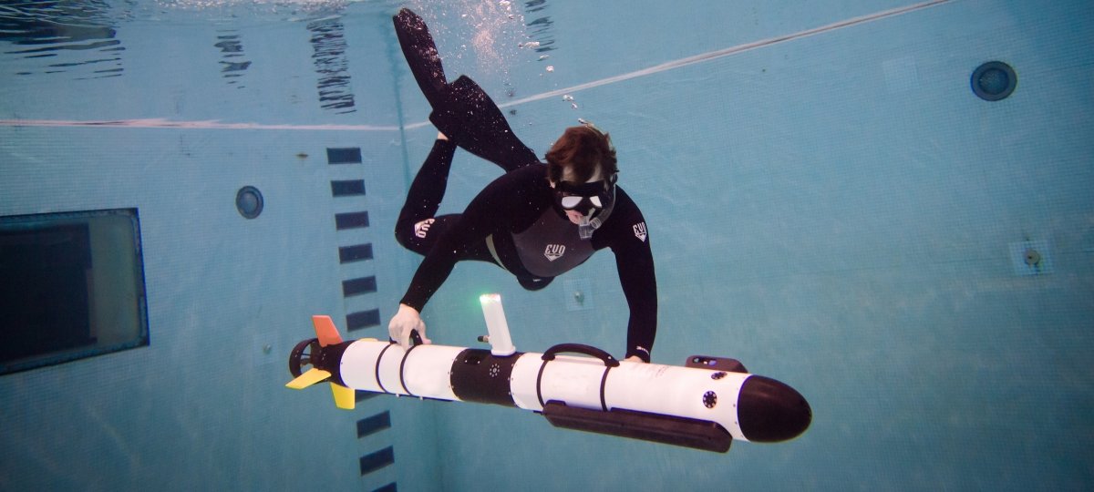 Pesron underwater launching an autonomous underwater vehicle.