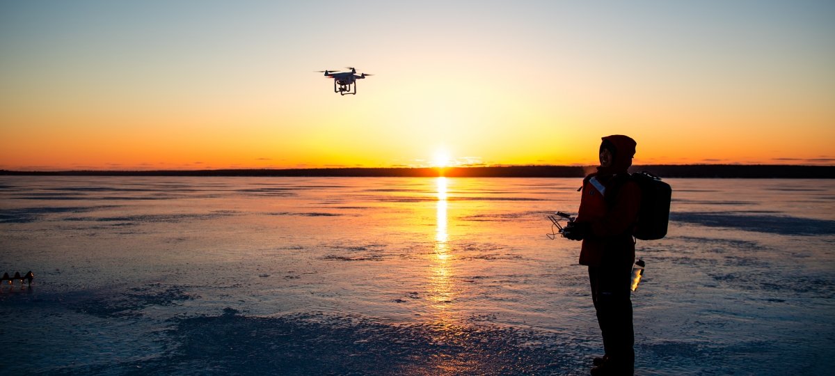 Person on the ice flying a drone.