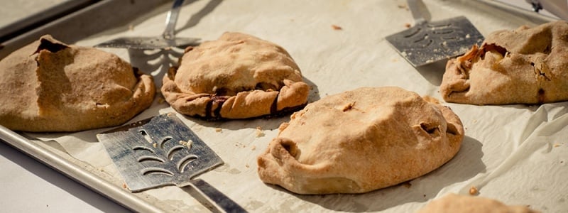 A tray of fresh-baked pasties. 