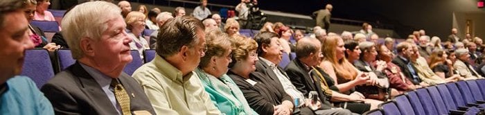 Many donors sitting in the Rozsa Center theater.