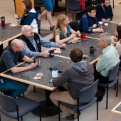 Faculty and staff chat in the forestry building atrium.