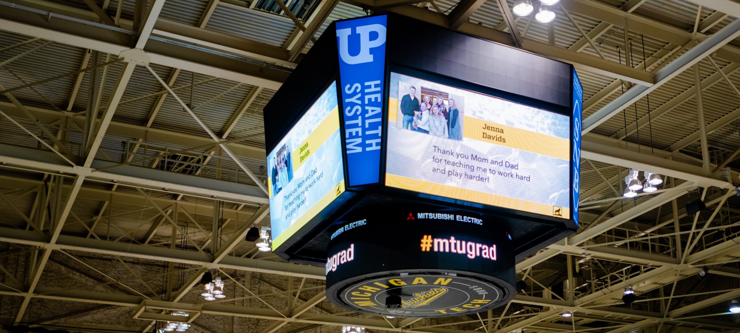 Large screen with Class Tribute displayed at Commencement in the SDC Hockey Arena.
