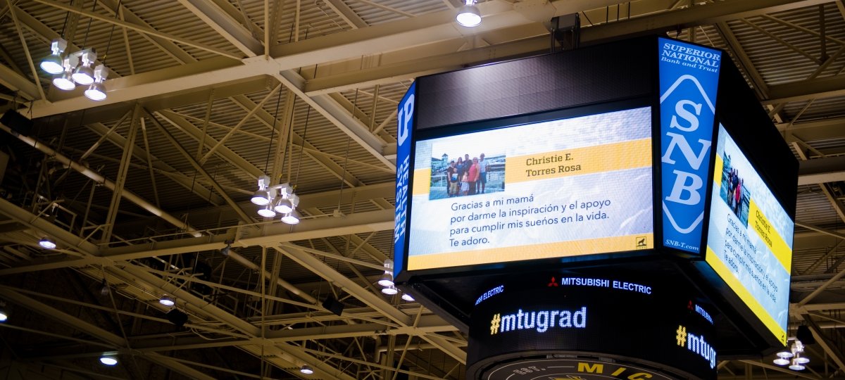Large screen with Class Tribute displayed at Commencement in the SDC Hockey Arena.
