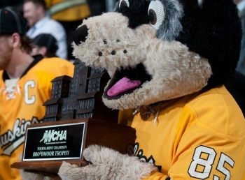 Mascot Blizzard T Husky holds the Broadmoor trophy.