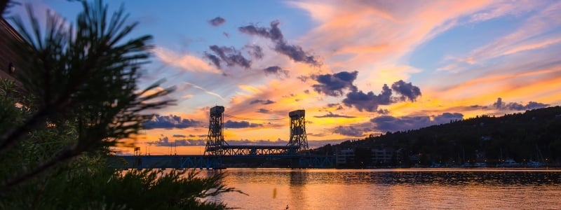 The sun sets behind the Portage Lake lift bridge.