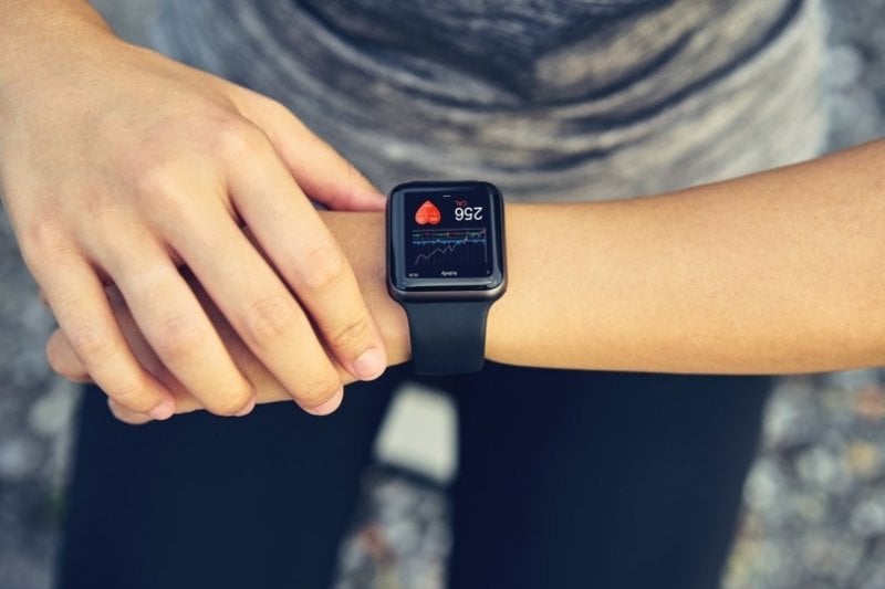 Woman checking her heart rate monitor watch.