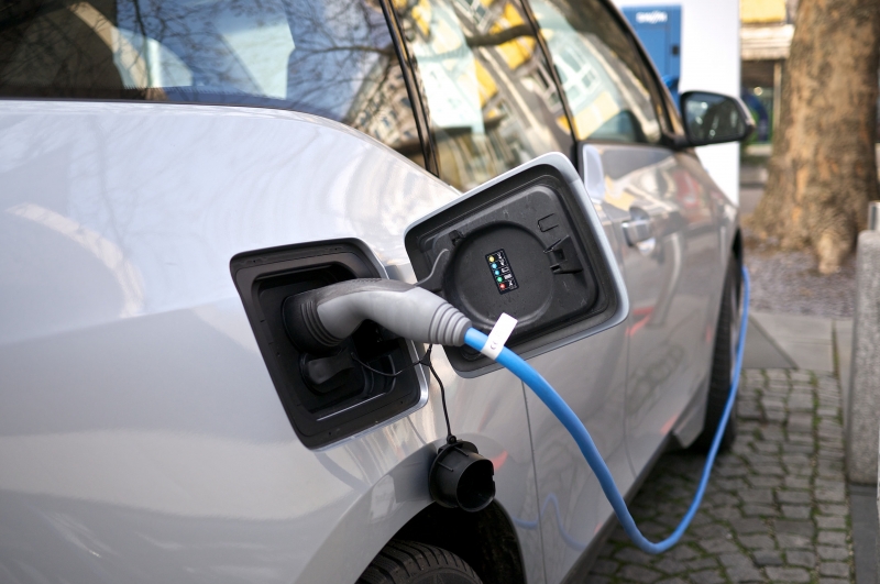 Close up of an electric car being charged.