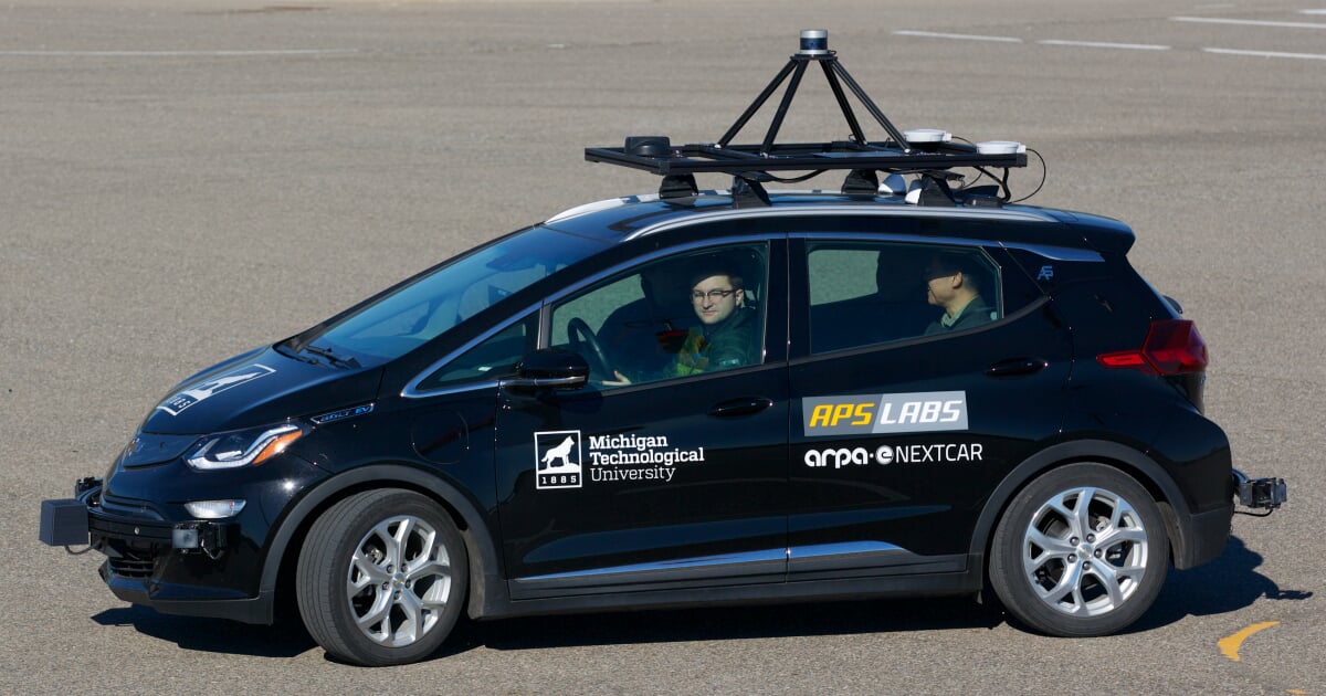 APS Labs Staff driving around a parking lot in the ARPA Nextcar.
