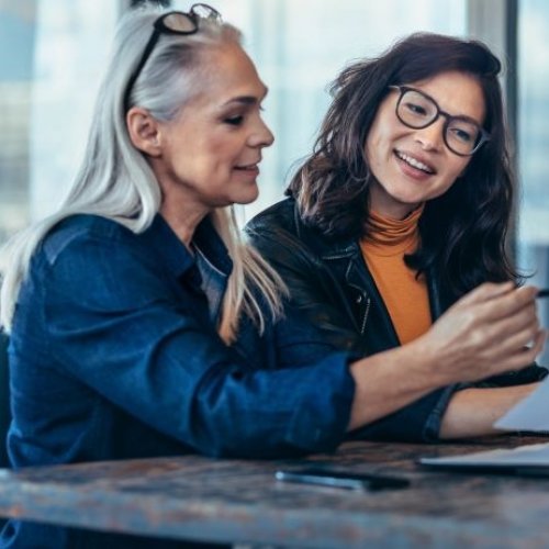 Two women chatting and problem-solving